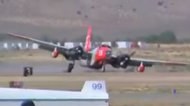 Lockheed P-2V fire bomber lands without left landing gear